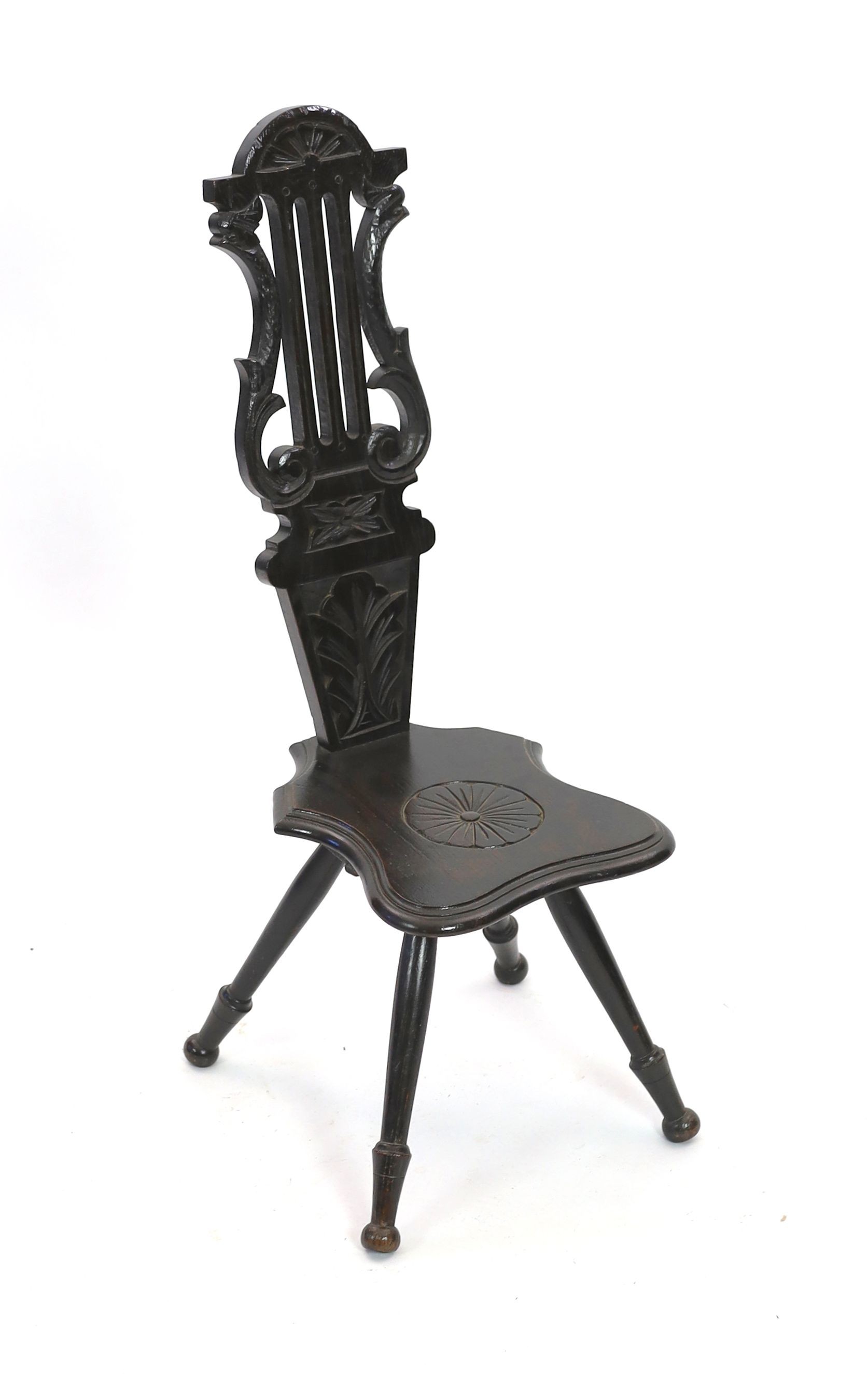 An early 20th century carved oak spinning chair, with lyre back, height 89cm